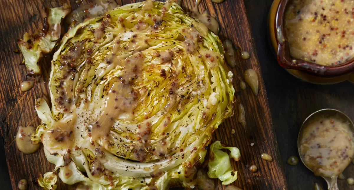 View Roasted Cabbage Steaks with Whole Grain Mustard Vinaigrette Gallery - Image 1 Roasted Cabbage Steaks with Whole Grain Mustard Vinaigrette